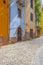 Panorama of the colorful town of Bosa along a river and hills in sunlight in spring