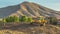 Panorama Construction site with focus on a bulldozer parked on top of a mound soil