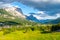 Panorama of Cortina d`Ampezzo with green meadows and alpine peaks on the background. Dolomites, Italy.