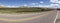Panorama of a country road disappearing into the distance.