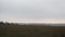 The panorama of the countryside with a view on the wooden Church.