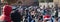 Panorama couple streamer vlogger and crowded people in warm jacket watching recording holiday parade street performance in Dallas