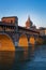 Panorama of covered bridge and Pavia cathedral at wonderful sunset