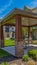 Panorama Covered patio on the lawn surrounded by house under blue sky