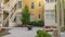 Panorama crop Fire pit and stone benches outside a multi storey residential building complex