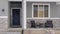 Panorama crop Home facade with gable roof front porch and door with wreath in winter