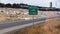 Panorama crop Passing Lane sign at the grassy side of road against snowy hill and cloudy sky