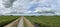 Panorama from dark clouds above the cows and farmland