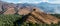 Panorama of date palms & mountains & ancient tower, Oman