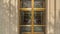 Panorama Decorative wrought iron door with gold frames in front of glass door of building