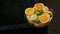 Panorama of deep glass bowl with sliced orange and lime circles