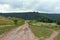 Panorama, dirt road with puddles of rainwater.