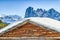 Panorama of the Dolomites with wood cottage, snowy mountains and