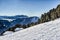 Panorama of the Dolomites with wood cottage, snowy mountains and