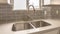 Panorama Double bowl stainless steel sink against tiled wall with window and cabinets