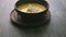 Panorama down on yellow cream soup decorated with mushrooms and dried bread