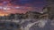 Panorama Dramatic sunset with clouds Uphill curved road cleared of snow in a residential area at Utah