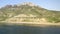 Panorama drone aerial view along sea coast. Calm still sea on mountain range