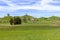 Panorama of drumlin hills with trees under blue sky i