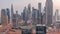 Panorama of Dubai Financial Center district with tall skyscrapers with illumination night to day timelapse.