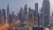 Panorama of Dubai Financial Center district with tall skyscrapers with illumination night to day timelapse.