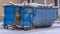 Panorama Dumpster on the snow covered ground against houses in Daybreak Utah