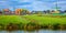 Panorama of a Dutch village with windmills, green houses pastures and meadows. Agricultural landscape. Tourism. Holland,