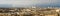 Panorama of Edinburgh with a little rainbow, in the background the water of the Firth of Forth and behind it the opposite shore.