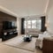 Panorama of elegant designed living room with window wall big television screen and wooden elements