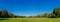 Panorama of empty Great Lawn of Central Park under clear blue sky, in Manhattan, New York City, USA