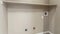 Panorama Empty laundry room interior with wall mounted shelf