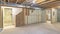Panorama Empty unfinished large basement with concrete flooring and wooden frames