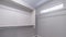 Panorama Empty walk in closet interior with small window carpet floor and white wall