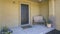 Panorama Entrance of a home with bench and potted flowering plants on the porch