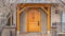 Panorama Entryway of home framed with leafless hibernating trees on the yard in winter