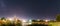 Panorama Of Evaporation Over River Lake Near Houses In Village. Night Starry Sky Above Lake River With Bright Stars And