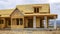 Panorama Facade of home under construction against snowy mountain and cloudy sky