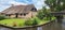 Panorama of a farm with thatched roof in Giethoorn