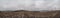 Panorama of the field in the fall. Arable land covered with snow