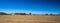 Panorama of field in western colorado with farms and snow capped