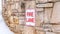 Panorama Fire Lane sign on stone retaining wall amid thick fresh snow on a hill in winter