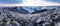 Panorama. First sunlight on an early cold winter morning with frozen grass mountain landscape and bright foggy glow