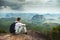 Panorama of fit and active young man resting after hike and enjoying view. Tab Kak Hang Nak Hill Nature Trail. Thailand.