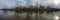 Panorama of flooded area next to levee with trees underwater near Sacramento