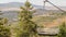 Panorama Focus on an empty chairlift against summer landscape of ski resort in Park City