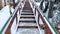 Panorama Focus on stairs with grate treads and metal handrails against snow covered hill