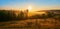 Panorama with foggy ravine and a hilly meadow