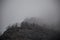 Panorama of the foggy winter landscape in the mountains with snow and rocks, Azerbaijan, Lahic, Big Caucasus