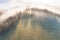 Panorama of a forest shrouded by low clouds. Rays of the sun. Autumn weather