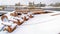 Panorama frame Adirondack wooden chairs on a deck overlooking lake and houses in winter